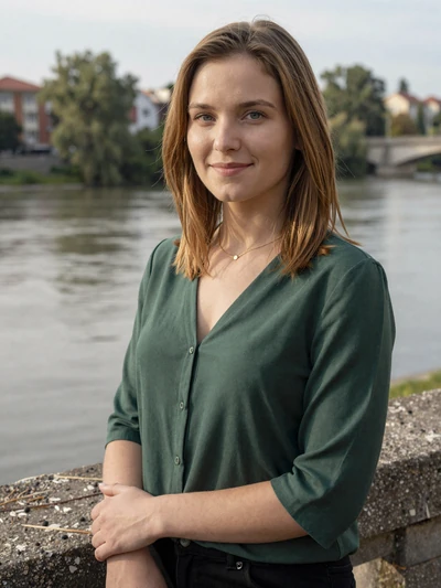 Zuzana, a 28-year-old Slovakian woman in green blouse with Danube river view in Bratislava